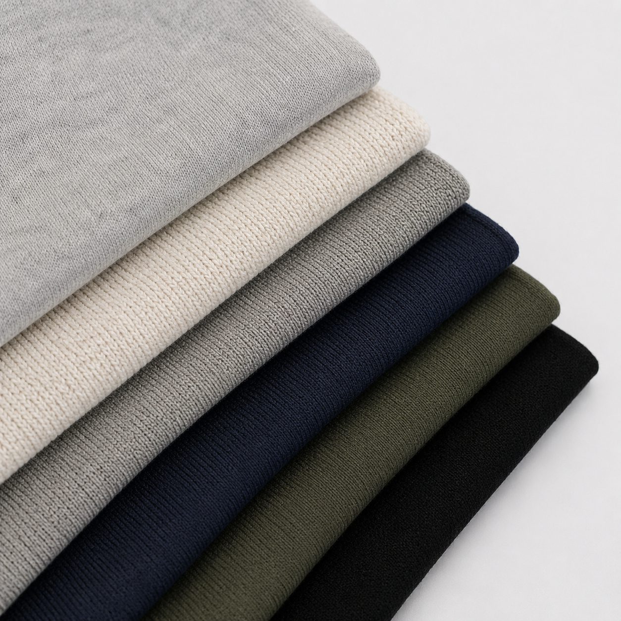 French terry fleece cotton blend and technical knit swatches for custom jogger manufacturing